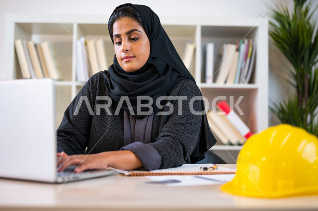 A Saudi Arabian Gulf university student studying architecture, studying university lectures, a diligent student studying in the university library, studying for exams, reading daily lessons, completing architectural project plans, a new engineering archit