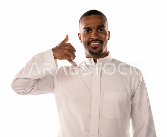 Portrait of a brown Saudi Arabian Gulf youth with a smiling face, hand movements indicating communication and communication, calls and inquiries, quick response, technical support, friendship and social relations, white background