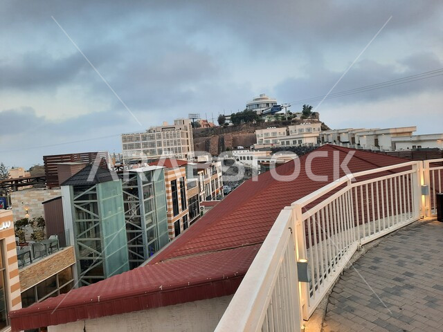 قضاء اوقات ممتعة في المناطق المرتفعة المشهورة، اطلالة مرتفعة على المباني السكنية والمراكز التجارية في مدينة أبها في منطقة عسير، معالم وأماكن سياحية في المملكة العربية السعودية، منظر السماء المليئة بالغيوم