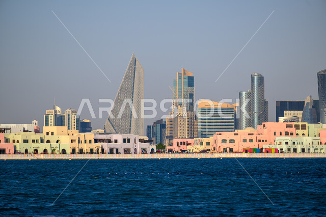 Buildings and structures in Doha Corniche during the day, the architectural art of towers and skyscrapers overlooking the sea, attracting and attracting tourists from all over the world, famous coastal landmarks and tourist places in Qatar