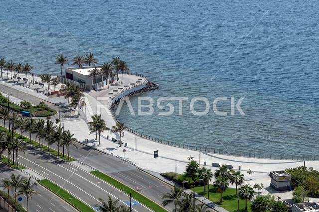 Famous landmarks of Jeddah, the seafront of the Jeddah Corniche in the Kingdom of Saudi Arabia, the calm sea waves on the beaches of the Corniche, the architectural art of the towers and skyscrapers, the trees and green plants surrounding the roads and public streets, tourist places in Saudi Arabia