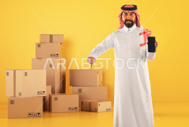 A Saudi Arabian Gulf man working in the delivery of orders and goods to customers, online shopping, online orders, warehouse keeper, order documentation, purchase and delivery through mobile applications, yellow background