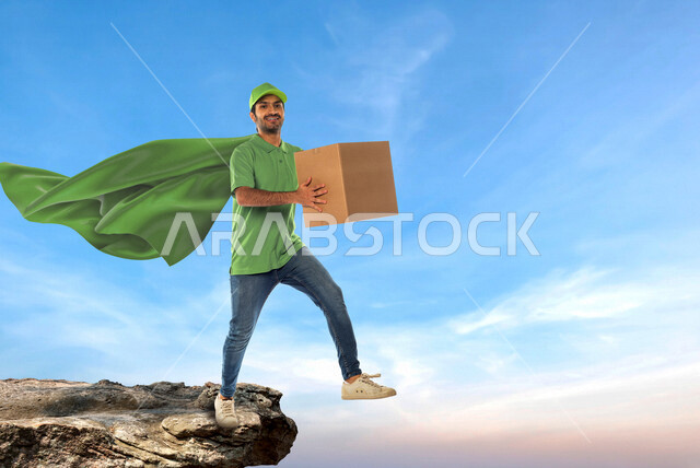 رجل عربي سعودي خليجي يرتدي رداء سوبرمان للتوصيل السريع يعمل في توصيل الطلبات والبضائع للزبائن, التسوق الالكتروني, طلبات اونلاين, التسوق الذكي, عملية شحن وتوصيل موثوقه, مندوب توصيل, خدمات التوصيل السريع