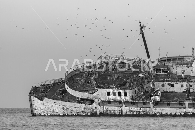 Famous monuments on the coasts and beaches of the Kingdom of Saudi Arabia, the sunken Al-Fahd ship in the sea of ​​Mecca near the city of Jeddah, the Saudi Titanic in black and white, the wrecked Al-Shuaiba ship, tourist sites and historical ports, the seafront, the sandy beach and the waves of the Gulf