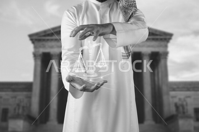 صورة مقربة لرجل محامي عربي سعودي خليجي يضع بين يديه ميزان العدل بخاصية الهولوجرام ثلاثية الأبعاد , محامي ينجز المهام القانونية , مفهوم العدالة والقانون .