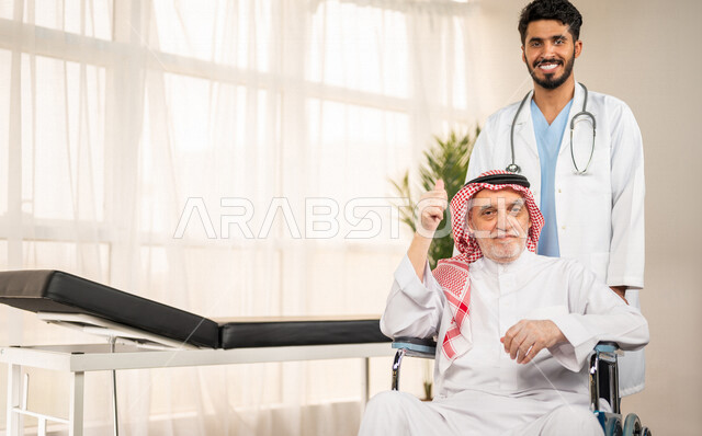 تقديم أفضل الخدمات الصحية لمرضى كبار السن في المستشفى , مريض مسن عربي سعودي خليجي يجلس على كرسي متحرك , يقوم بشكر وتقدير الطبيب لجهوده ورعايته الطبية , مفهوم الطب والرعاية الصحية .