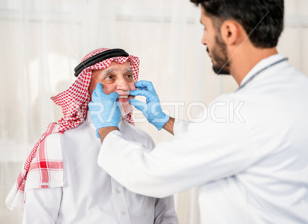 A Saudi Arabian Gulf dentist examining the patient’s teeth, preserving the patient’s teeth, the concept of medicine and health care, medical professions and jobs, working in the health sector to provide health services, white background.
