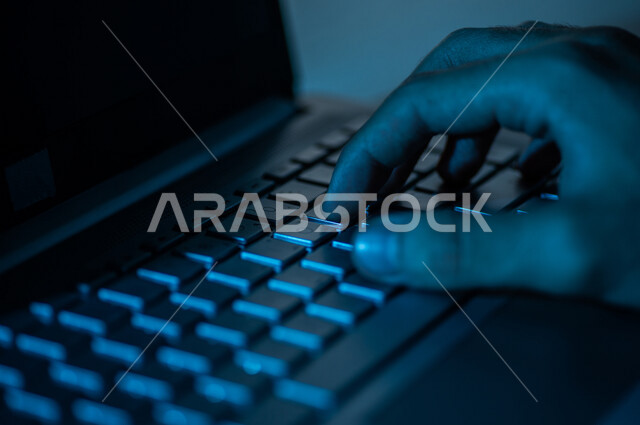 صورة مقربة ليد رجل عربي خليجي سعودي يستخدم الحاسوب المحمول ،الكتابة من خلال لوحة المفاتيح ، ادخال البيانات، صناعة المحتويات النصية،التسويق والترويج للمواقع الالكترونية، القيام بالاعمال الادارية ،التعليم الالكتروني