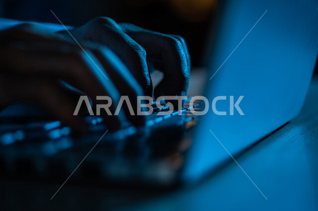 صورة مقربة ليد رجل عربي خليجي سعودي يستخدم الحاسوب المحمول ،الكتابة من خلال لوحة المفاتيح ، ادخال البيانات، صناعة المحتويات النصية،التسويق والترويج للمواقع الالكترونية، القيام بالاعمال الادارية ،التعليم الالكتروني