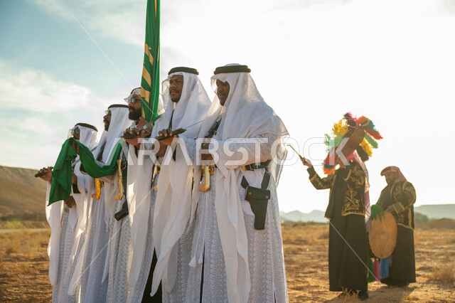 ارتداء زي العرضة النجدية الشعبية في المناسبة الوطنية، يوم بدينا ٢٢ فبراير، مفهوم حب الوطن والانتماء اليه، ذكرى تاسيس الدوله السعوديه الاولى ١٧٢٧ م، فرقة عروض الفلكلور التراثي في صحراء المملكة، الاحتفال باليوم الوطني بالرقص بالسيوف وقرع الطبول
