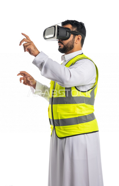 Portrait of a Saudi Arabian Gulf engineer wearing a work jacket and virtual reality glasses, using the sense of touch to control the elements of 3D virtual reality, virtual reality technology in architecture, white background