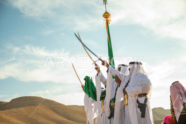 A band celebrating the National Day with sword dancing and drumming, the anniversary of the founding of the first Saudi state in 1727 AD, traditional folklore shows in one of the desert areas of the Kingdom, the concept of love of the homeland and belonging to it, the day we started on February 22, wearing the popular Najdi Ardah costume on a national occasion