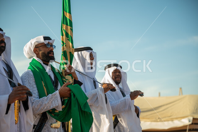 Traditional folklore shows in one of the desert areas of the Kingdom, the concept of love of the homeland and belonging to it, a band celebrating the National Day by dancing with swords and beating drums, the day we started on February 22, wearing the popular Najdi Ardah costume on a national occasion, the anniversary of the founding of the first Saudi state 1727 AD