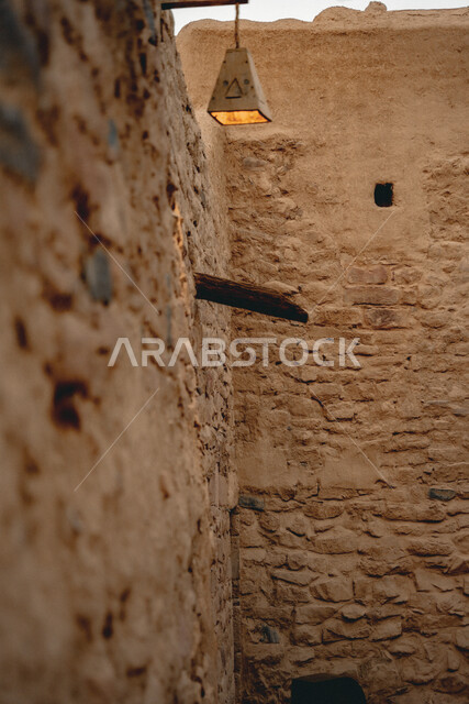 Traditional lamp hanging on a wall in the old town, popular historical buildings, ancient clay architecture, famous heritage tourist places in Saudi Arabia, tourism in AlUla city