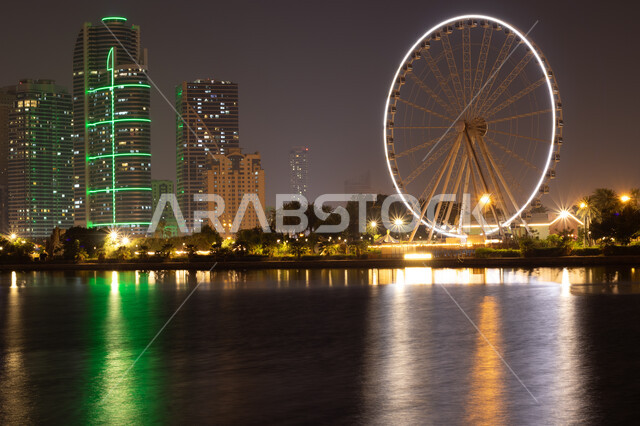 Ain Dubai Ferris Wheel illuminated at night in Sharjah, modern architectural style, Ferris wheel overlooking the waterfront, amusement park in the United Arab Emirates, famous tourist place and landmark