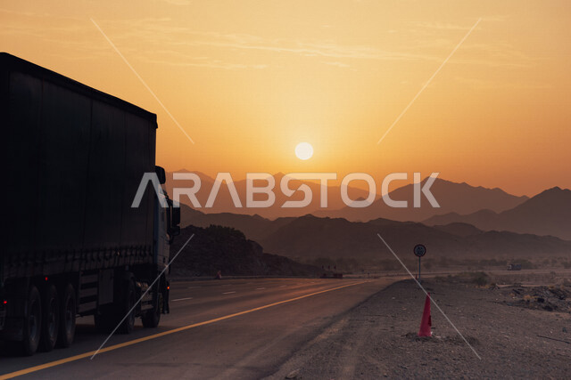 Beautiful view of the highway in Saudi Arabia at sunset and sunrise with a background of mountain heights, twisting highway in Saudi Arabia between sand dunes in the desert, typical asphalt road, nature in Saudi Arabia, desert road