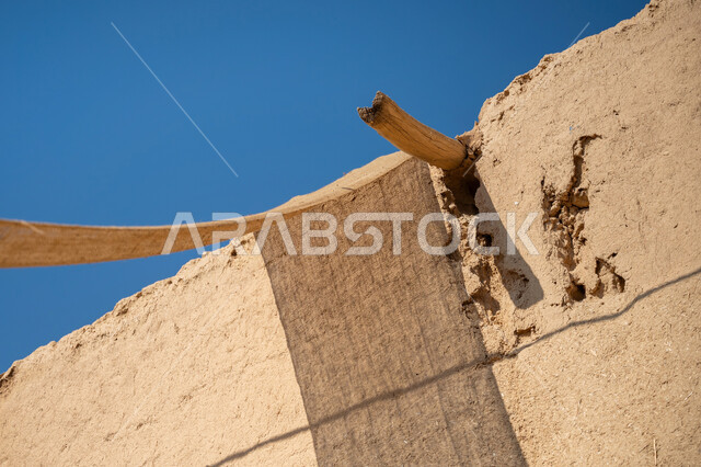 Historical monuments in the Kingdom, the anniversary of the founding of the first Saudi state 1727 AD, the day we started February 22, a traditional mud house built of bricks in the old style, a close-up of the wooden support of the cloth canopy, fabrics stretched between the houses to provide shade in an old inherited way