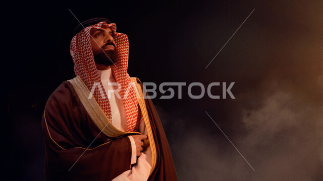 التأمل و التفكر والتطلع لمستقبل زاهر في المملكة, ذكرى تاسيس الدوله السعوديه الاولى ١٧٢٧ م، صورة مقربة لرجل عربي خليجي سعودي مبتسم يرتدي الغترة والبشت ينظر الى شيء ما، الاهتمام بالأناقة والمظهر الخارجي، يوم بدينا ٢٢ فبراير، رؤية سعودية 2030, خلفية سوداء