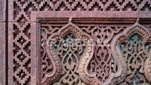 A close-up of some decorative shapes carved on the rocks, stone shapes, decorative details, stone carving