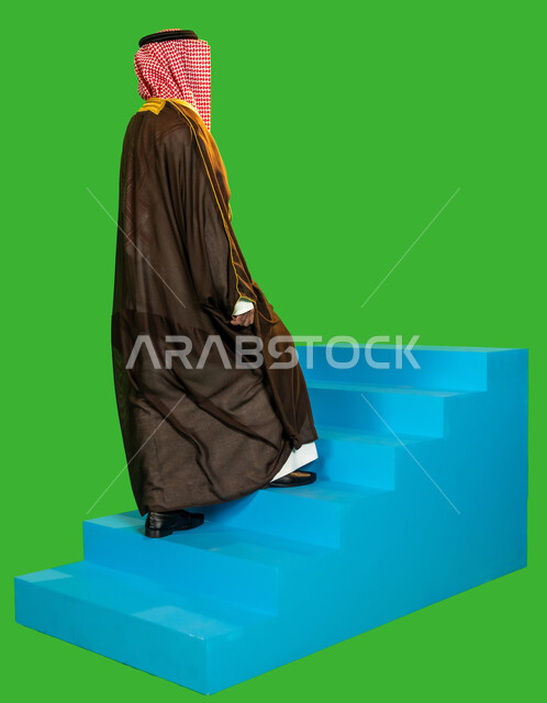 Authenticity and antiquity among Arabs, wearing traditional dress on a national occasion, the anniversary of the founding of the first Saudi state 1727 AD, the day we started February 22, a side portrait of a Saudi Gulf Arab man wearing a bisht and a shemagh climbing a blue staircase, full body length, green background, chroma key