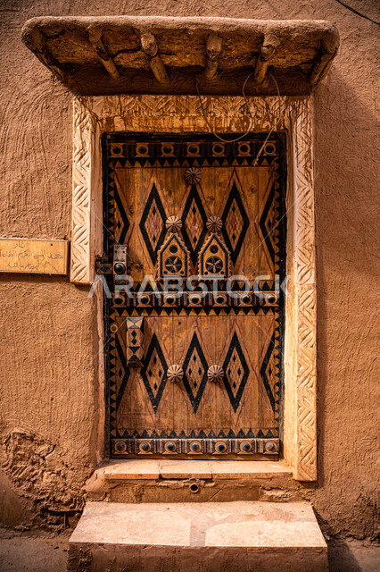 Historic houses in the Kingdom, ancient architectural design of ancient wooden doors, the day we started, February 22, a close-up of a wooden door decorated with geometric shapes, the anniversary of the founding of the first Saudi state 1727 AD, the authenticity of Saudi heritage