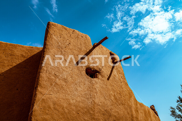 Historical folk villages, the anniversary of the founding of the first Saudi state 1727 AD, the day we started on February 22, traditional architectural art, ancient mud walls in the heritage village, white clouds in the sky, wooden columns to support the mud houses