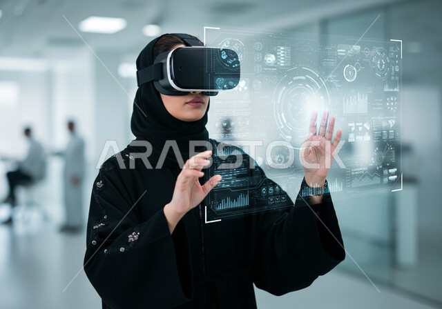 تداول العملة الرقمية، سوق الأوراق المالية, مفهوم التحليل المالي وفرص الاستثمار, هبوط وصعود أسهم البورصة, امرأة عربية خليجية سعودية محجبة ترتدي عباءة سوداء تضع نظارة الفي ار تقوم بمشاهدة الأرقام و الإحصائيات المالية, رموز وعناصر هولوجرامية ثلاثية الأبعاد مضيئة