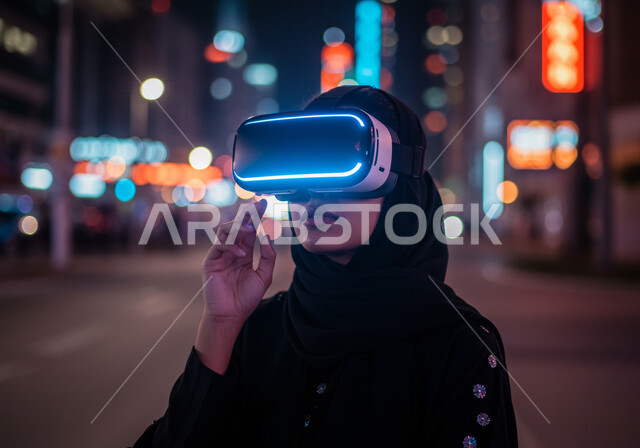 Integration and interaction with holographic elements, expressions of trying to grab something, the concept of technical and technological development, the use of modern and advanced technical devices, simulating the imaginary world, a close-up image of a veiled Saudi Arabian Gulf woman wearing a black abaya and virtual reality glasses