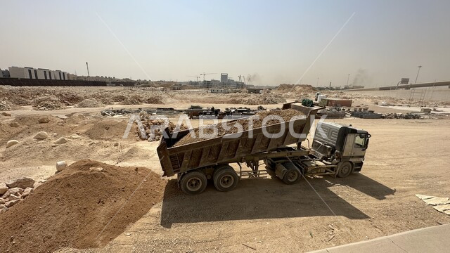 Industrial engineering profession and job in Saudi Arabia, reliance on heavy machinery and equipment in construction work, a huge vehicle that works in filling rubble and dirt at the work site, the concept of architectural and construction engineering, improving the infrastructure for the construction of modern buildings and projects in the city of Riyadh