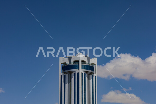 Distinctive architectural engineering art in the design of the Olaf International Hotel in Taif, urban growth and development in the Kingdom of Saudi Arabia, luxury hotels and tourist resorts, the concept of tourism in the Gulf countries, towering towers and skyscrapers, blue sky background with clouds during the day