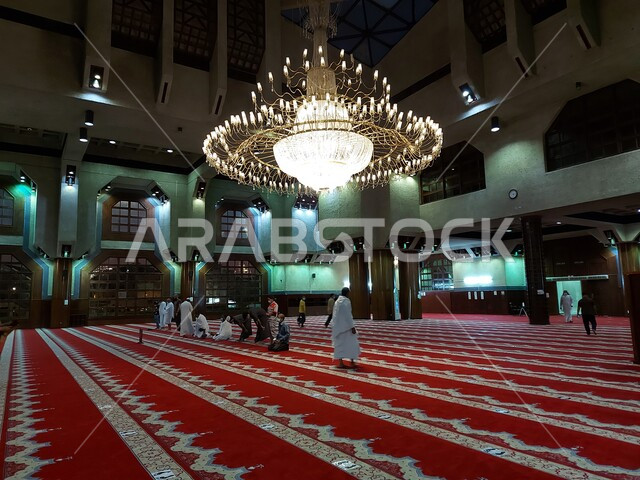 A group of Muslim pilgrims wearing Ihram perform prayers at Sayyida Aisha Mosque in Miqat At Tan'eem in Makkah, preparing to perform Hajj in Makkah, Saudi Arabia, Hajj season 2025, worship and drawing closer to Allah