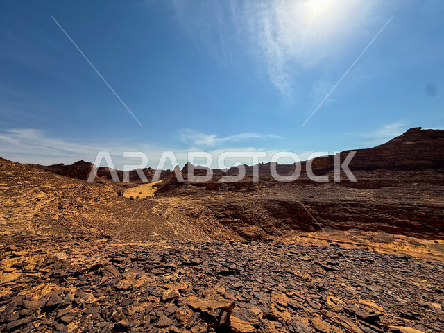 Natural mountain peaks and heights in the desert areas of AlUla, ancient historical monuments, rock formations and mountains amidst the sandy nature during the day, a famous tourist place and area in the Kingdom of Saudi Arabia