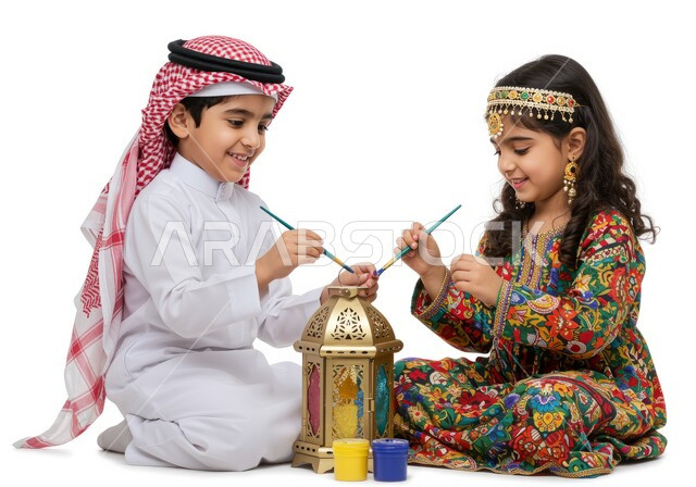 Playing, having fun and having fun, spending quality time with siblings enjoying and having fun, portrait of a Saudi Arabian Gulf child wearing traditional clothing and wearing a shemagh playing with his sister on Ramadan nights, decorations and decor for Islamic occasions and holidays, happy family atmosphere, white background