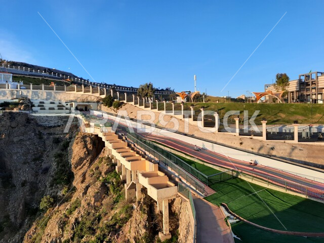 A distinctive landscape in a park in the Kingdom of Saudi Arabia, interest in planting green plants in parks and public gardens, Prince Hussam Park in Al-Baha Governorate, a famous tourist landmark, a place of attraction and attraction for tourists, the rock formation and formation of the mountain