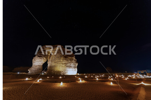 Topography in the mountain peaks and heights, enjoyment in the desert of the Kingdom, ancient historical monuments, mountains and rock formations in the desert areas, Elephant Rock in Al-Ula Governorate in Saudi Arabia, a famous tourist place illuminated at night