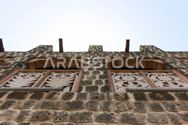 A close-up of the wall of one of the ancient heritage buildings in the Dubai Creek neighborhood, the charm and beauty of the tourist monuments in Dubai in the United Arab Emirates