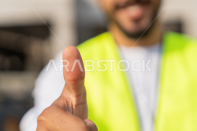 ادارة المشاريع الهندسية والانشاءات، دراسة المخطط والمشروع على ارض الواقع، مهنة ووظيفة هندسية شبابية، مهندس عربي خليجي اماراتي يرتدي الكندورة والسترة يرفع اصبع الابهام بتعابير الاعجاب والرضا، العمل في القطاع الهندسي في الامارات، الاشرف على عمليات البناء
