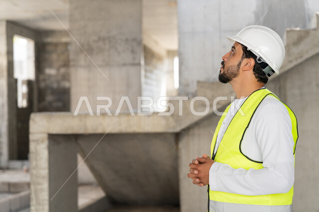 Construction Supervisor, Engineering Project Management Concept, Study of Plan and Project on the Ground, Youth Engineering Profession and Job, Arab Gulf Emirati Engineer Wearing Kandora, Jacket and Protective Helmet Working in the Engineering Sector in the United Arab Emirates