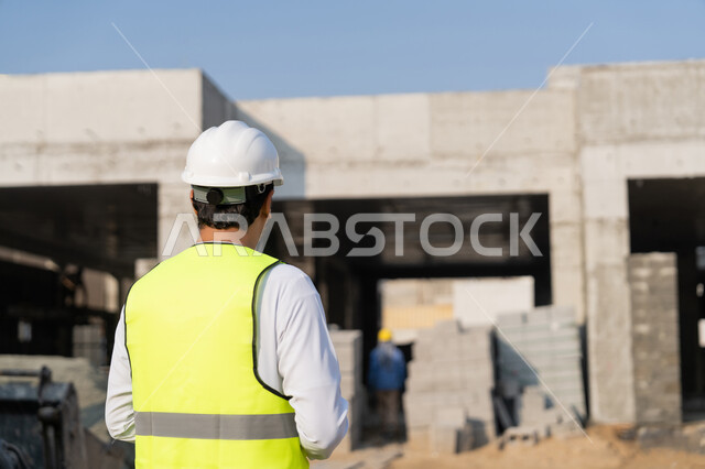 Construction Supervisor, Engineering Project Management Concept, Study of Plan and Project on the Ground, Youth Engineering Profession and Job, Arab Gulf Emirati Engineer Wearing Kandora, Jacket and Protective Helmet Working in the Engineering Sector in the United Arab Emirates