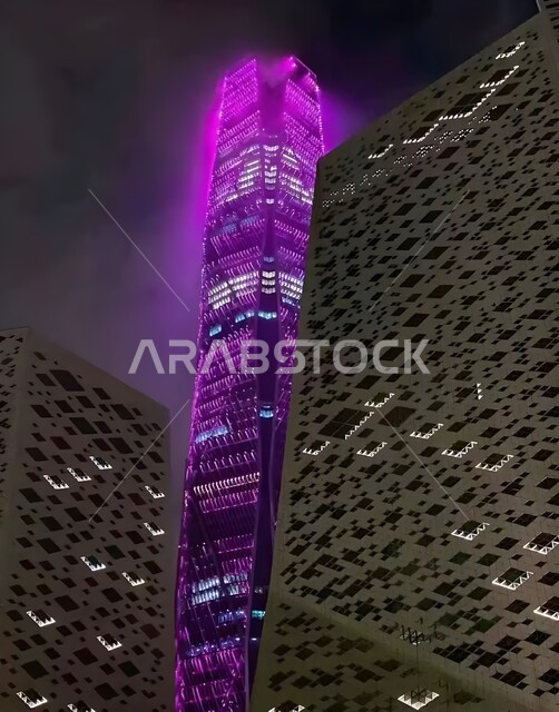 النمو والتقدم العمراني لناطحات السحاب في المملكة العربية السعودية، الفن الهندسي المعماري على الطراز الحديث والمتطور، اضاءة أبراج مدينة الملك عبد الله المالية كافد في الرياض باللون البنفسجي في الليل، الوجهة الرئيسية للمال والاعمال، تحقيق النهضة الاقتصادية والتجارية