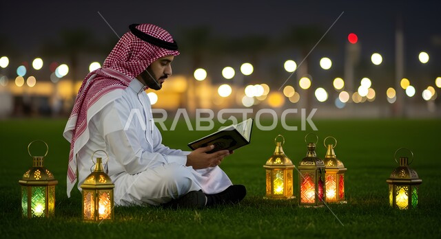 Reciting and memorizing the Holy Quran in the spiritual atmosphere of Ramadan, a Saudi Arabian Gulf man wearing the traditional thobe and shemagh reading the Holy Quran, sitting next to the illuminated lanterns in the open air at night, getting closer to God in the holy month of Ramadan, striving in worship and performing religious duties
