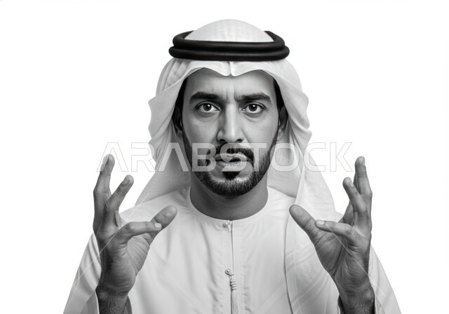 Trying to hold something, looking at the camera with a serious and firm expression, close-up portrait of an Emirati Gulf Arab man wearing a kandura and ghutra raising his hands up, gestures of ignorance and questioning, white background