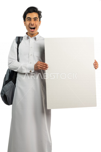 Portrait of a Saudi Arabian Gulf student holding an explanatory board in his hand, following daily lectures and lessons, teaching using explanatory boards and teaching aids, educational enrichment activities, education in the Kingdom of Saudi Arabia