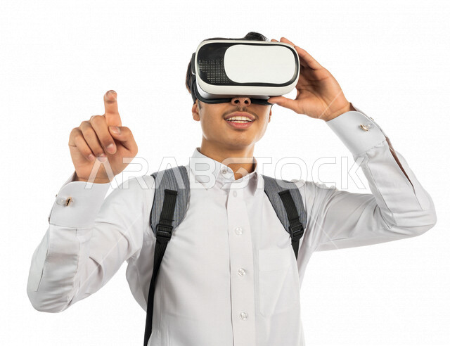 Portrait of a Saudi Arabian Gulf university student wearing 3D virtual reality glasses and pointing the index finger at something, clicking and pressing, linking virtual reality to education and training, simulating the virtual world, finger movement and