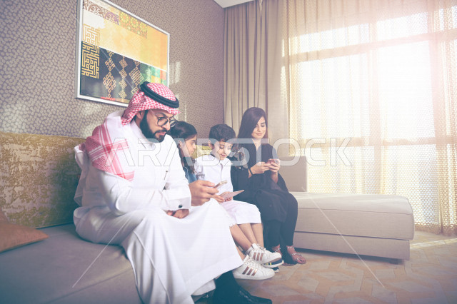 عائلة عربية خليجية سعودية تستخدم الاجهزة الالكترونية المحمولة ، التفاعل مع العالم الافتراضي ، التسوق الالكتروني ، مشاهدة الافلام والمسلسلات ، اجواء عائلية