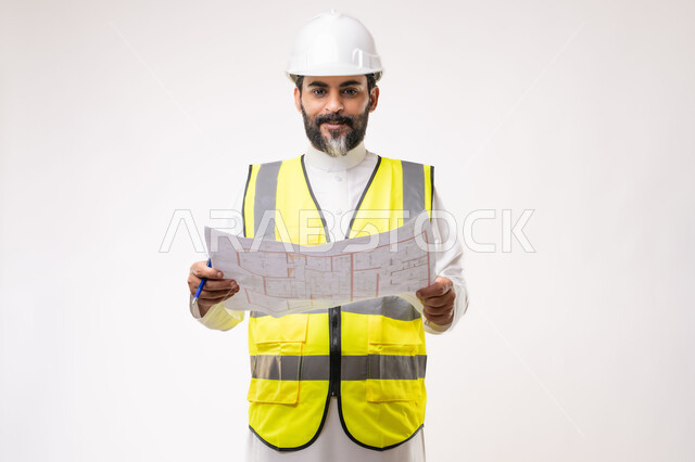 Engineering and construction project management, concept of planning and construction project study, youth engineering profession and job, portrait of a Saudi Arabian Gulf engineer wearing traditional thobe, jacket and protective helmet working in the engineering sector in the Kingdom of Saudi Arabia, white background