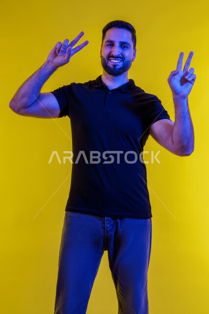 Gestures of joy and happiness, a young Emirati Gulf Arab man wearing casual clothes and sunglasses smiling, portrait of a young Saudi Arab man showing gestures of confidence and smiling, yellow background
