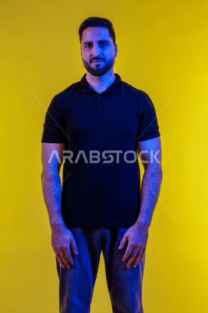 Masculinity and self-confidence, taking selfies for official documents of a smiling Emirati man, portrait of a young Saudi Arabian Gulf man wearing casual clothes looking at the camera with gestures of self-confidence, a Saudi man interested in elegance and appearance, yellow background