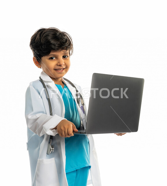 Portrait of a Saudi Arabian Gulf boy, wearing a doctor's uniform, using a laptop, a little doctor, the future profession, the concept of medicine, the use of technology and modern technical devices, white background, distance study, e-learning