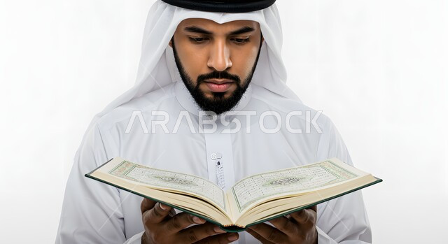 Gestures of diligence and humility in worship, drawing closer to the Lord of the Worlds, a close-up portrait of an Emirati Gulf Arab man wearing a kandura and ghutra, holding the Holy Quran in his hand, reading and reciting, white background